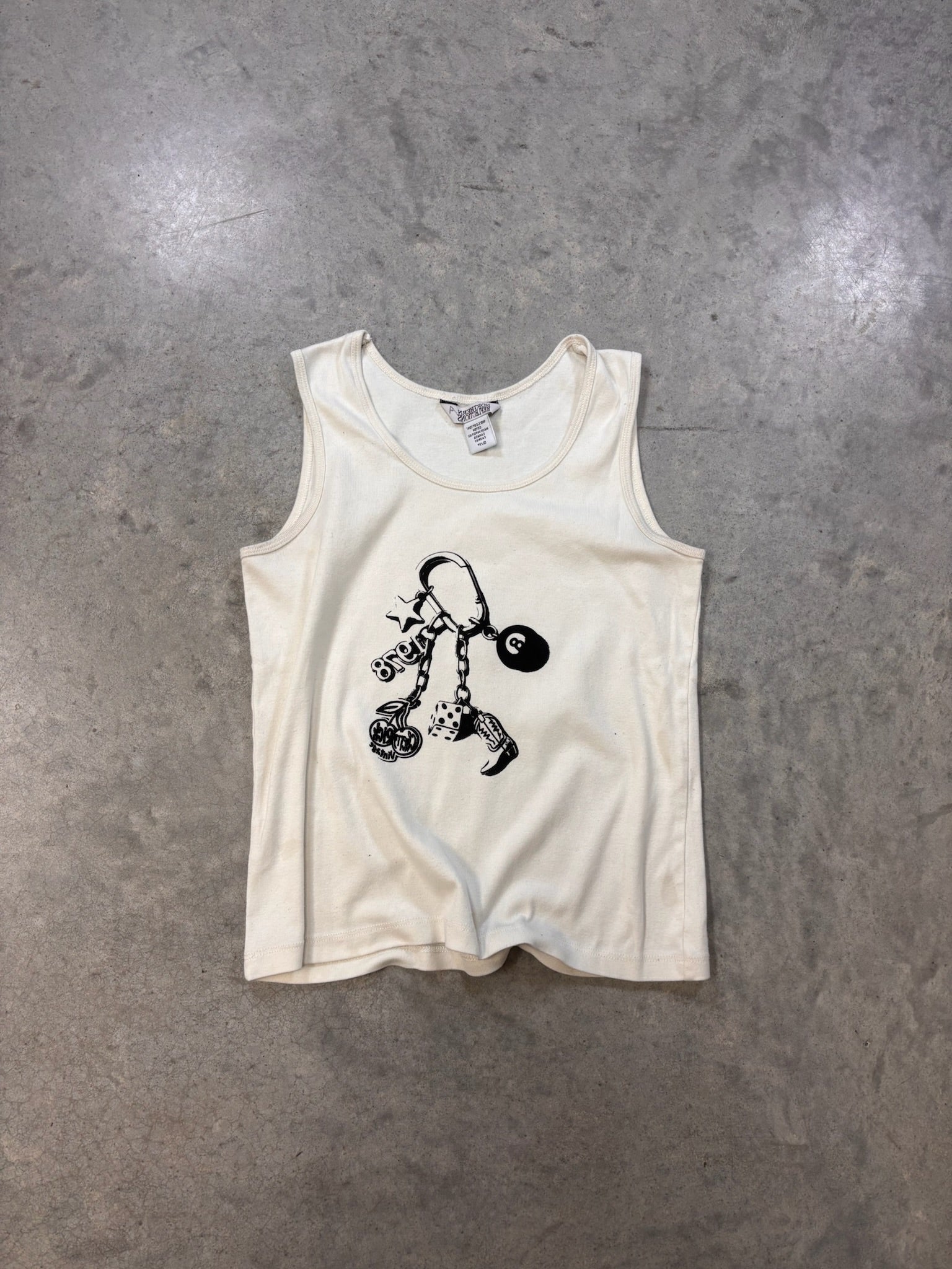 White baby onesie with black graphics on a gray surface